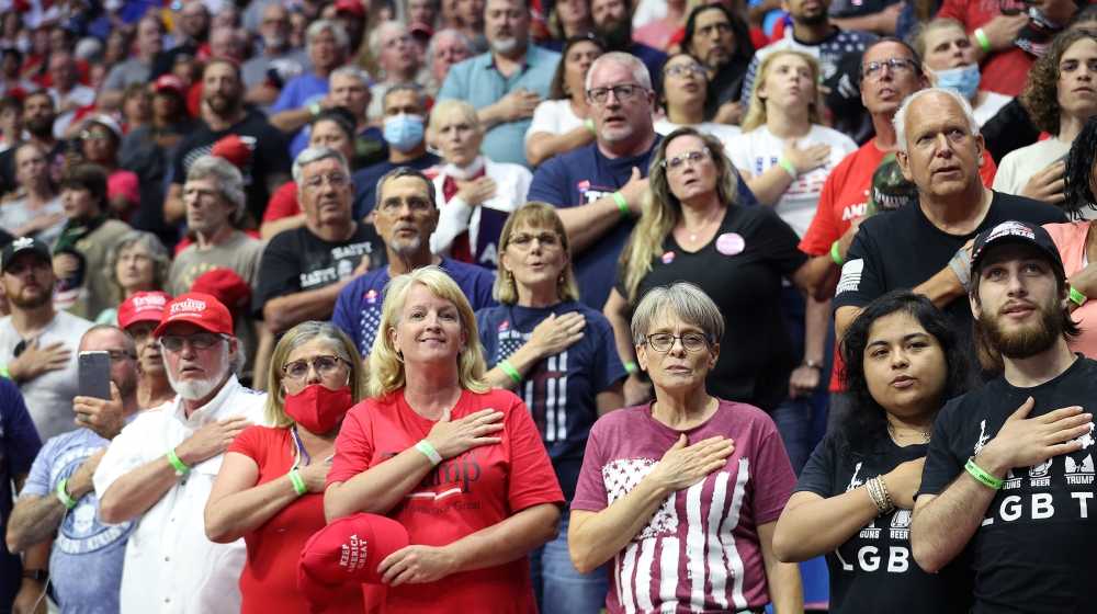 Supporters participate in the Pledge of Allegiance during a campaign a Trump rally in Tulsa, Oklahoma where social distancing and face masks appear to have been loosely considered [Win McNamee/Getty Images/AFP] 