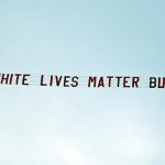 A racist banner reading 'White lives matter Burnley' is towed by a plane above the stadium during the English Premier League football match between Manchester City and Burnley at the Etihad Stadium in Manchester, north west England, on June 22, 2020. (AFP)