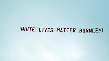 A racist banner reading 'White lives matter Burnley' is towed by a plane above the stadium during the English Premier League football match between Manchester City and Burnley at the Etihad Stadium in Manchester, north west England, on June 22, 2020. (AFP)