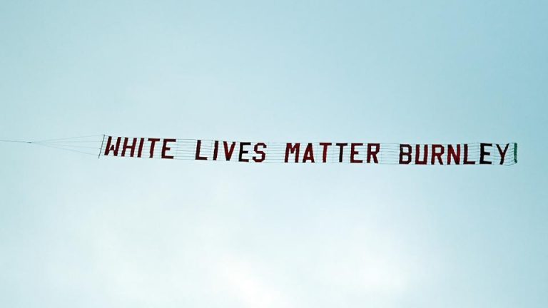 A racist banner reading 'White lives matter Burnley' is towed by a plane above the stadium during the English Premier League football match between Manchester City and Burnley at the Etihad Stadium in Manchester, north west England, on June 22, 2020. (AFP)