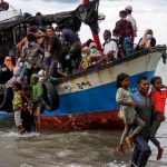 Locals evacuate Rohingya refugees from a boat at a coast of North Aceh, Indonesia, June 25, 2020. (Reuters)
