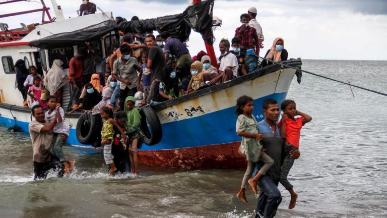 Locals evacuate Rohingya refugees from a boat at a coast of North Aceh, Indonesia, June 25, 2020. (Reuters)