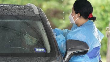A healthcare professional, right, takes a sample from a patient at a United Memorial Medical Center COVID-19 testing site Wednesday, June 24, 2020 - Copyright David J. Phillip/AP Photo