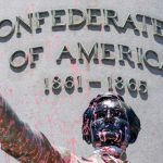 Paint and protest graffiti covers the Jefferson Davis Memorial in Richmond following a week of unrest in the US against police brutality and racism in policing [J Scott Applewhite/AP Photo]