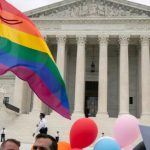 LGBT supporters wave their flag in front of the U.S. Supreme Court on Oct. 8, 2019, in Washington, when the court heard arguments on LGBT rights cases. (Manuel Balce Ceneta/The Associated Press)