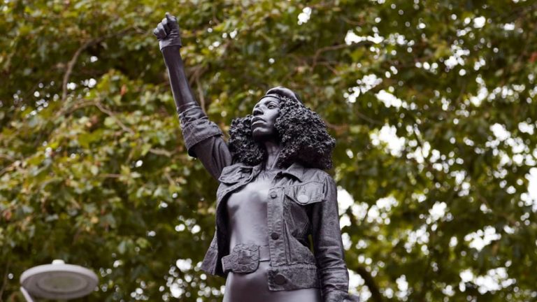 Black Lives Matter protester rises in place of destroyed slave trader statue